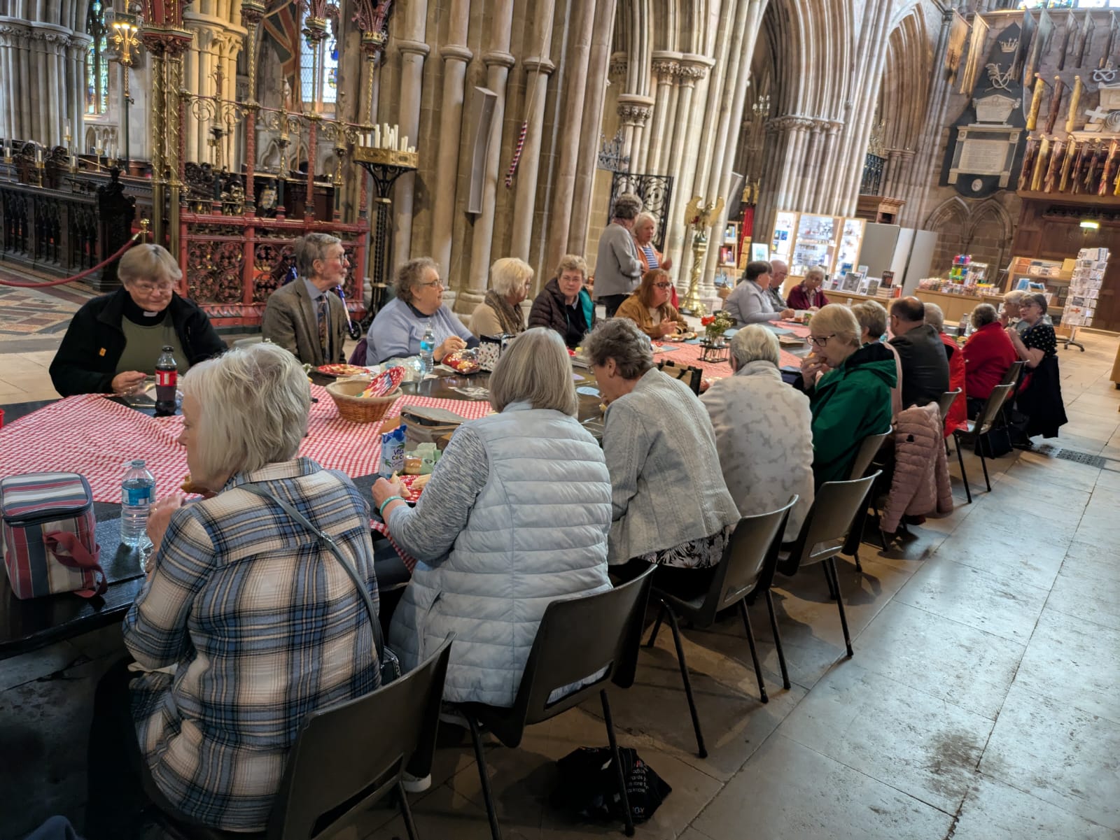 People sitting around the very long Fenland Black Oak Table in Lichfield Cathedralat the last Dementia network gathering in the cathedral. 